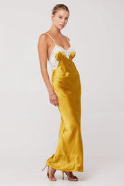 This is an image of Celine Dress in Gold - RESA featuring a model wearing the dress