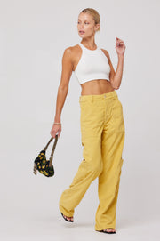 This is an image of Elsa Cargo Pant in Mustard - RESA featuring a model wearing the dress