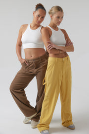 This is an image of Elsa Cargo Pant in Mustard - RESA featuring a model wearing the dress