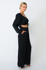 This is an image of Everly Blouse in Black - RESA featuring a model wearing the dress