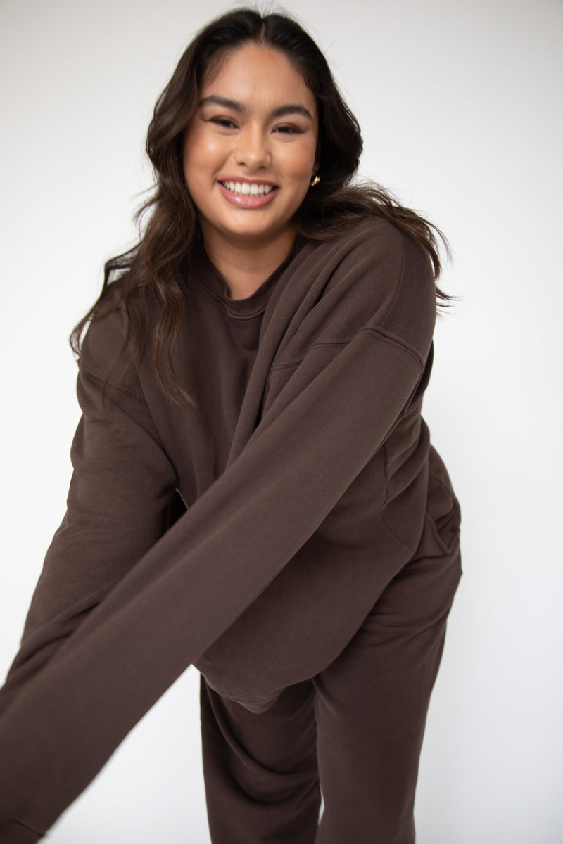 This is an image of Gunner Sweatshirt in Tobacco - RESA featuring a model wearing the dress