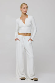 This is an image of Henley Rib in White - RESA featuring a model wearing the dress