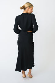 This is an image of Isla Skirt in Black - RESA featuring a model wearing the dress