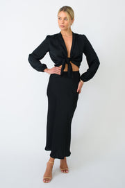 This is an image of Isla Skirt in Black - RESA featuring a model wearing the dress