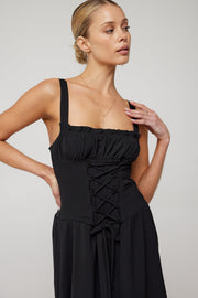 This is an image of Izzy Dress in Black - RESA featuring a model wearing the dress