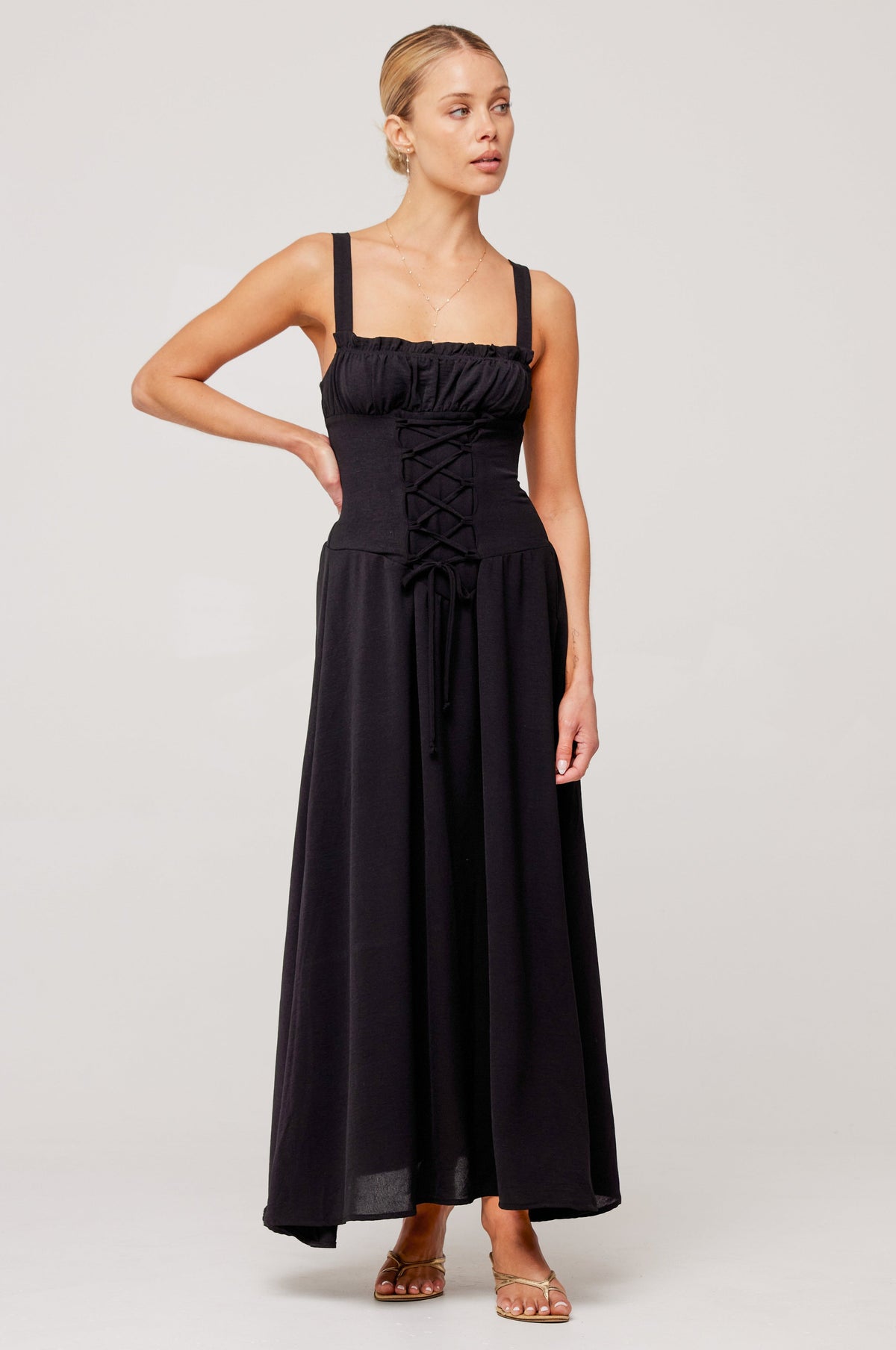 This is an image of Izzy Dress in Black - RESA featuring a model wearing the dress