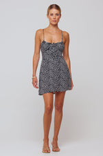 This is an image of Juniper Mini in Black Polka Dot - RESA featuring a model wearing the dress