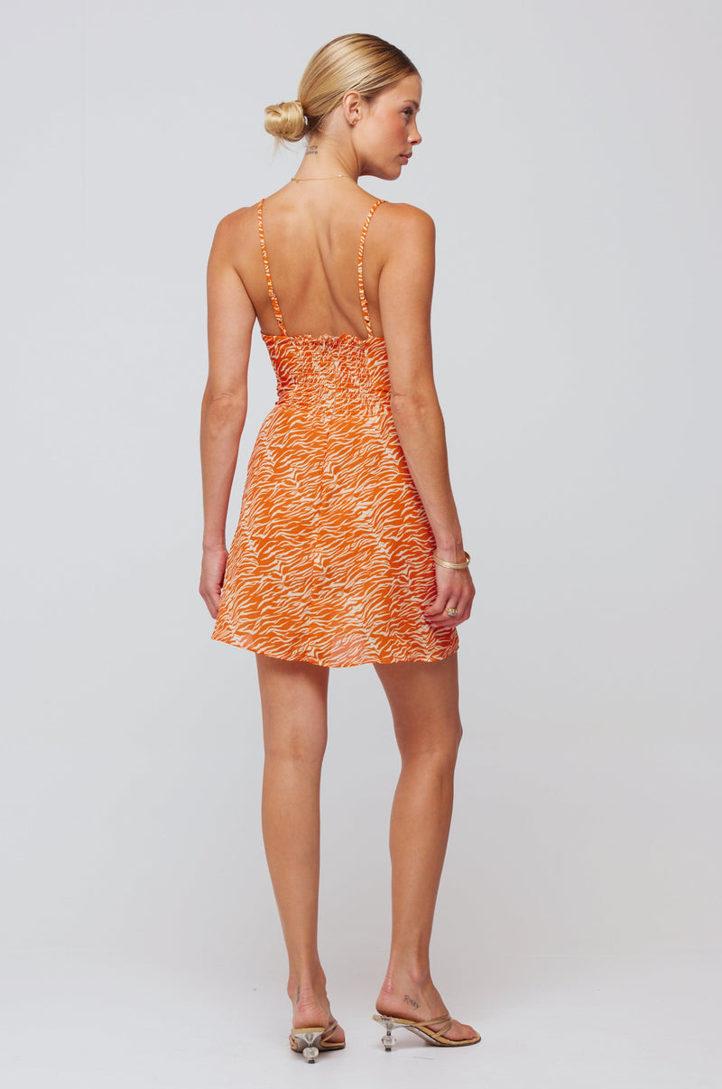 This is an image of Juniper Mini in Orange Zebra - RESA featuring a model wearing the dress