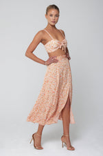 This is an image of Katie Crop in Sunstone - RESA featuring a model wearing the dress