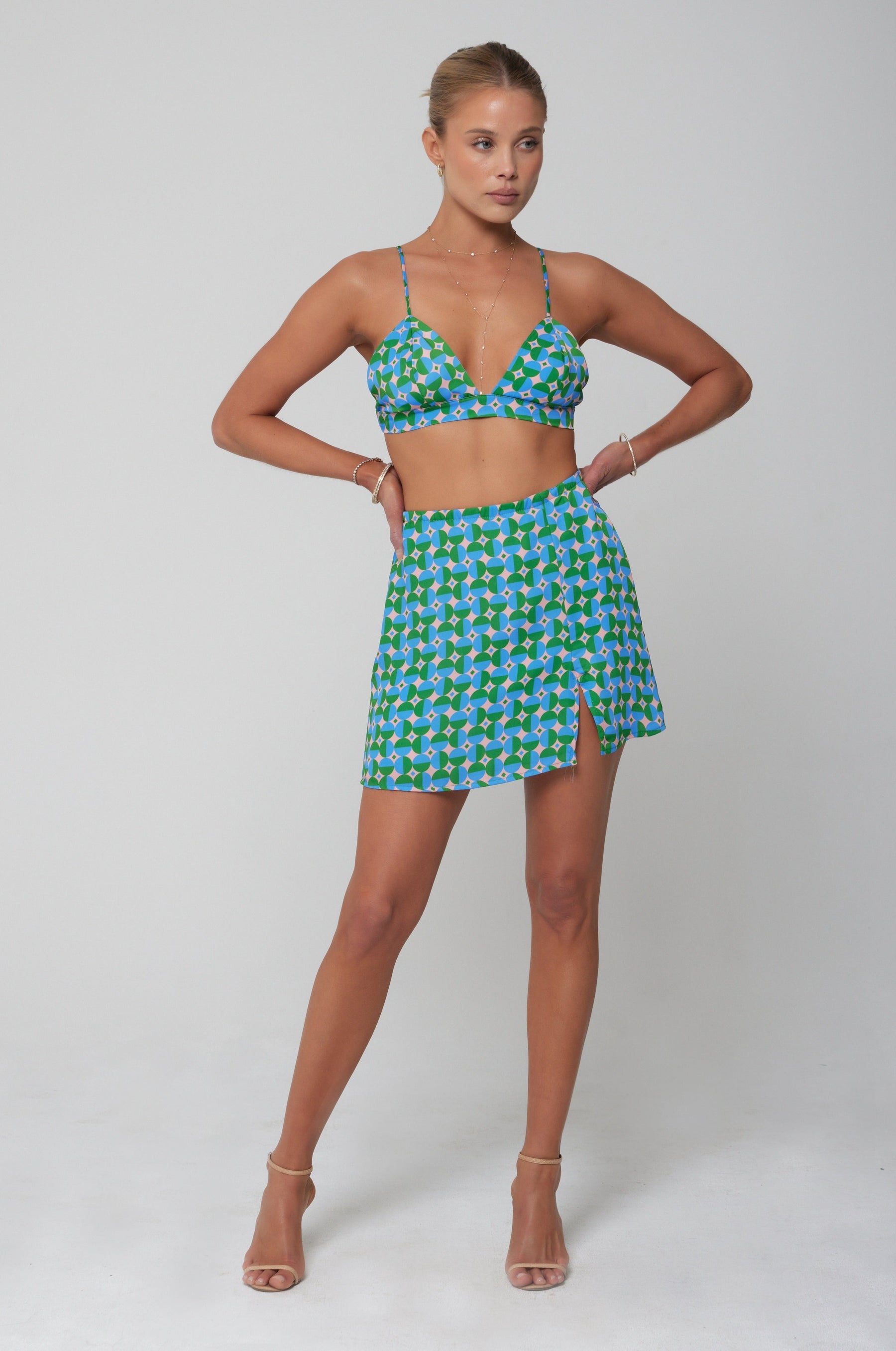 This is an image of Kenzie Skirt in Oasis - RESA featuring a model wearing the dress