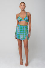 This is an image of Kenzie Skirt in Oasis - RESA featuring a model wearing the dress