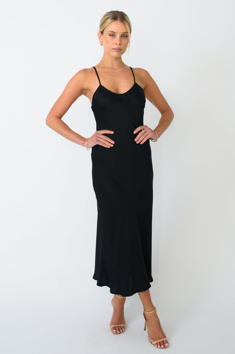 This is an image of Lily Slip in Black - RESA featuring a model wearing the dress