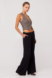 This is an image of Malcolm Trousers in Black - RESA featuring a model wearing the dress