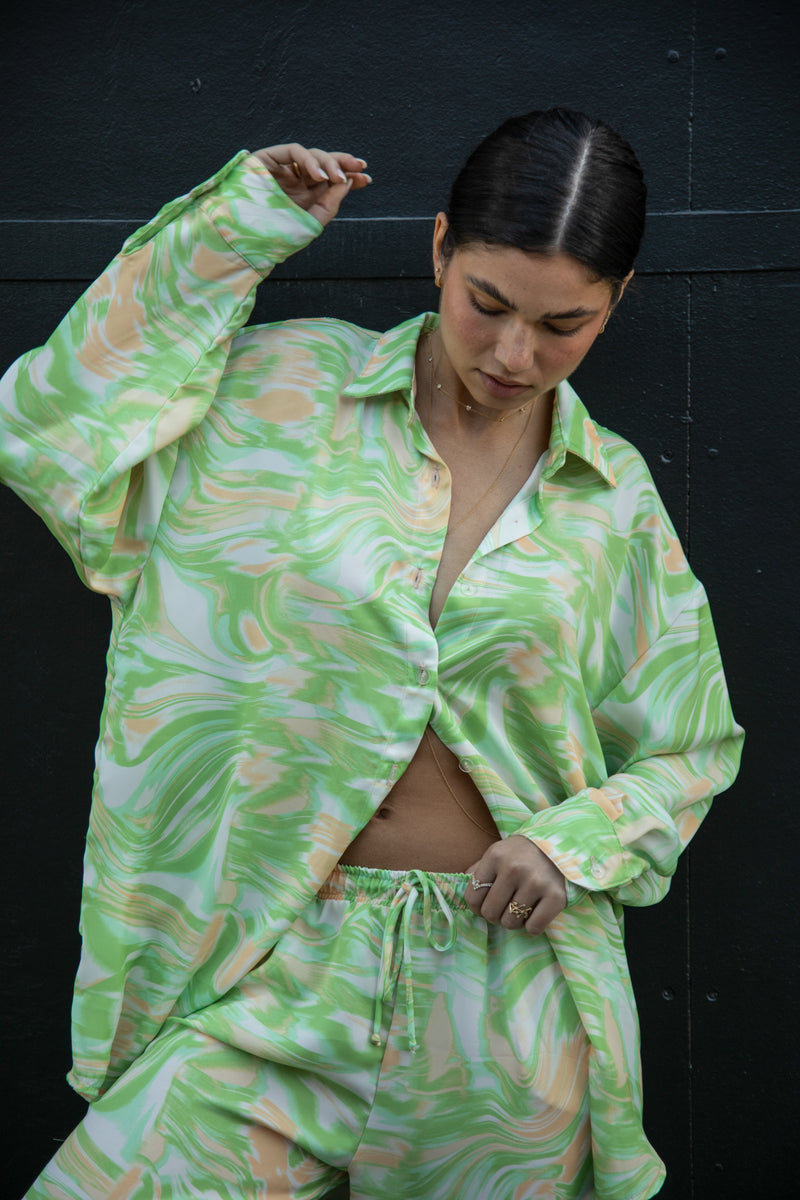 This is an image of Monica Blouse in Limestone - RESA featuring a model wearing the dress