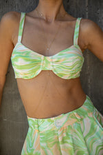 This is an image of Pepper Bra in Limestone - RESA featuring a model wearing the dress