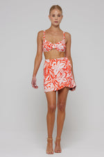 This is an image of Pepper Bra Top in Clementine - RESA featuring a model wearing the dress