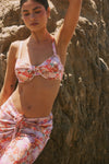 This is an image of Pepper Bra Top in Coral - RESA featuring a model wearing the dress