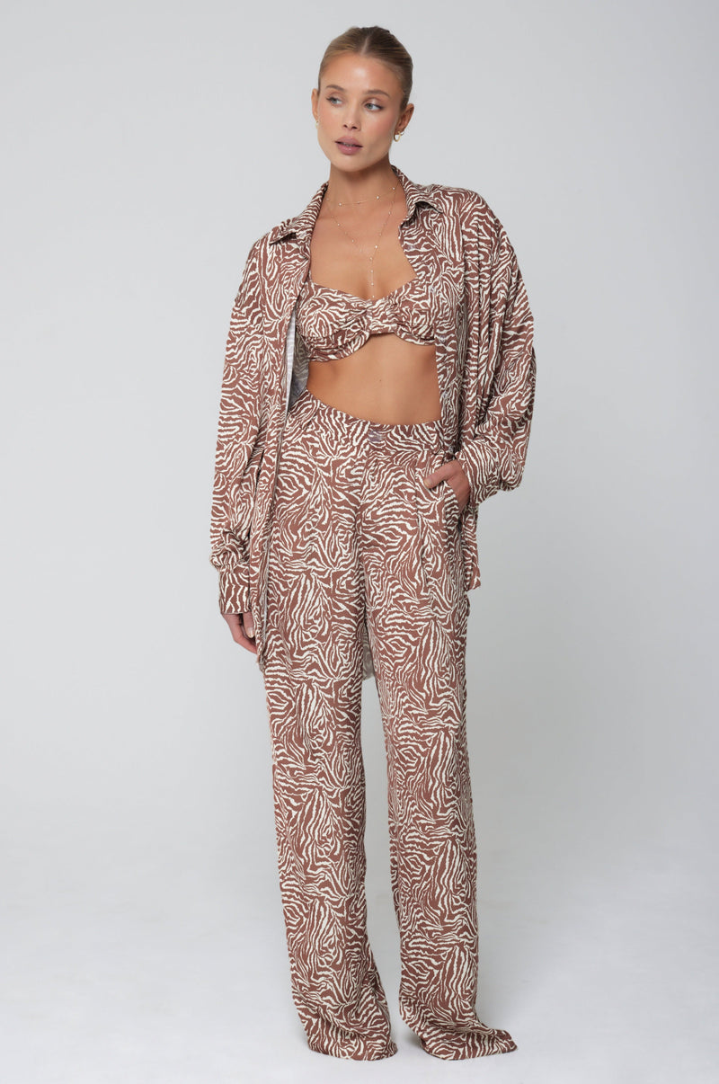 This is an image of Pepper Bra Top in Dallas - RESA featuring a model wearing the dress