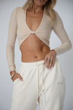 This is an image of Quinn Top in Cream - RESA featuring a model wearing the dress