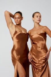 This is an image of River Slip in Copper - RESA featuring a model wearing the dress