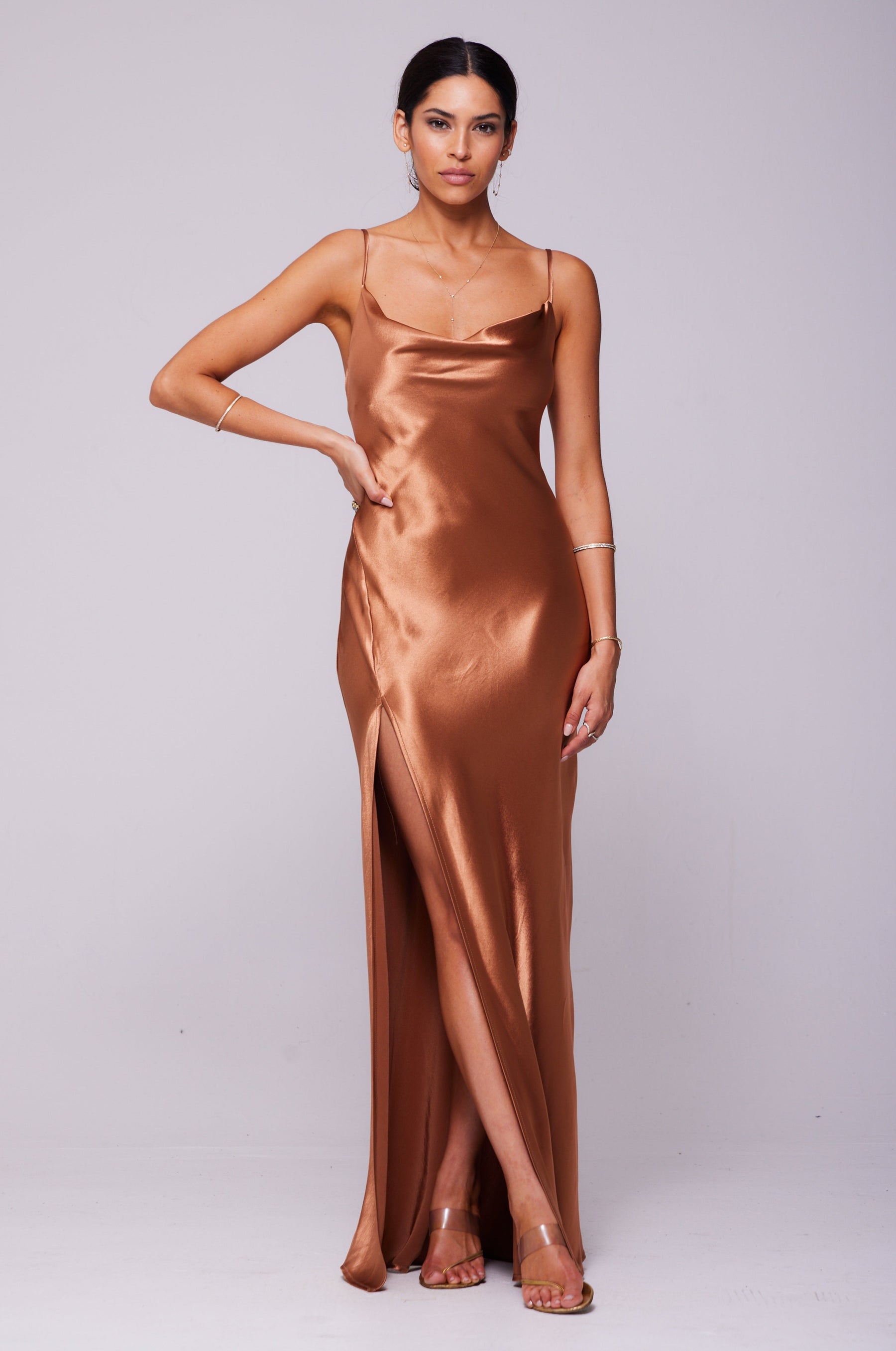 This is an image of River Slip in Copper - RESA featuring a model wearing the dress
