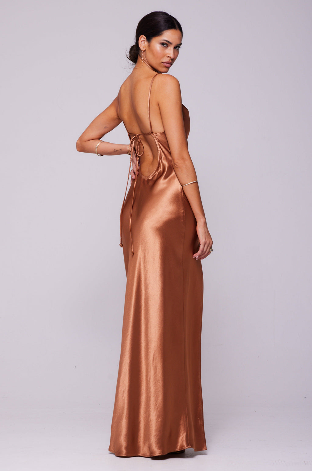 This is an image of River Slip in Copper - RESA featuring a model wearing the dress