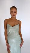 This is an image of River Slip in Sage - RESA featuring a model wearing the dress