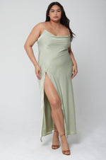 This is an image of River Slip in Sage - RESA featuring a model wearing the dress