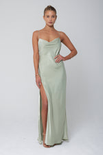 This is an image of River Slip in Sage - RESA featuring a model wearing the dress