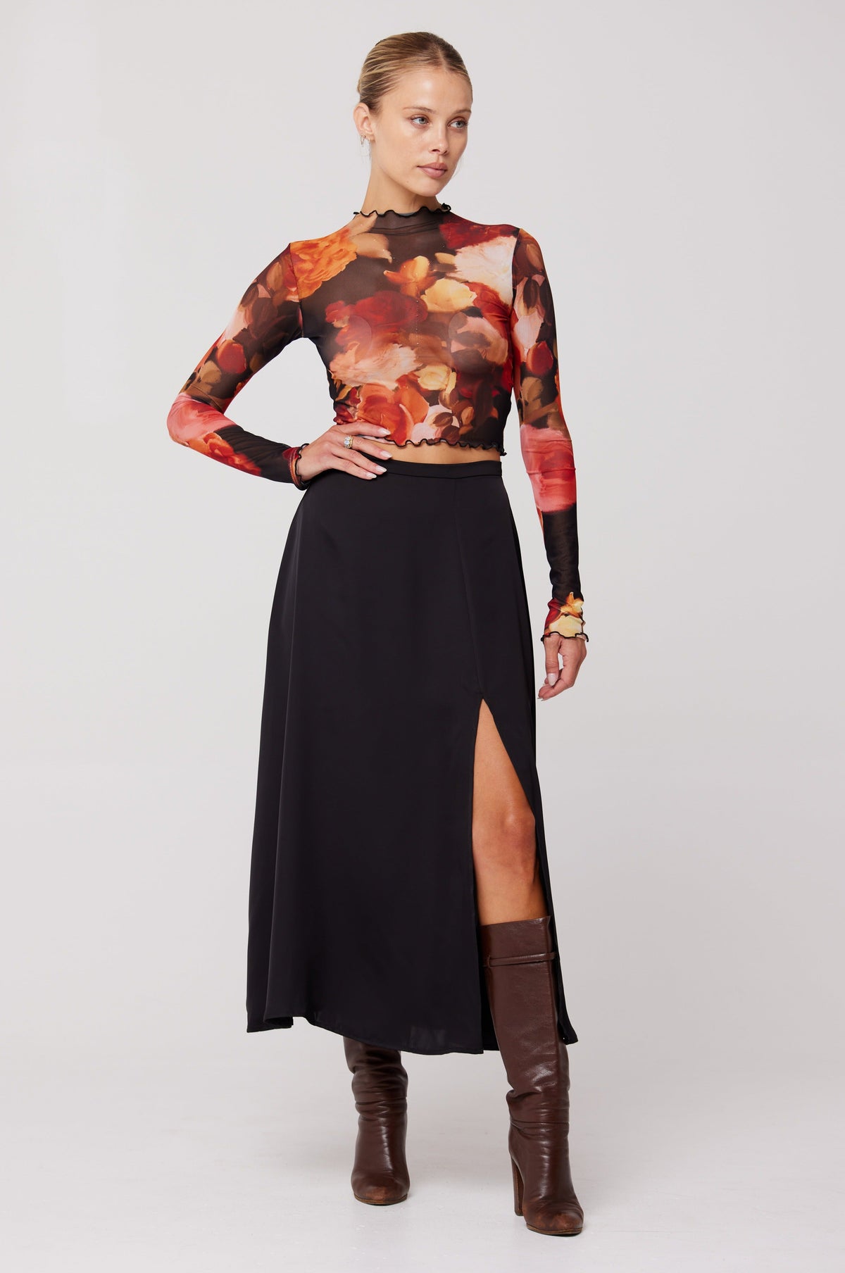 This is an image of Skatie Midi Skirt in Black - RESA featuring a model wearing the dress