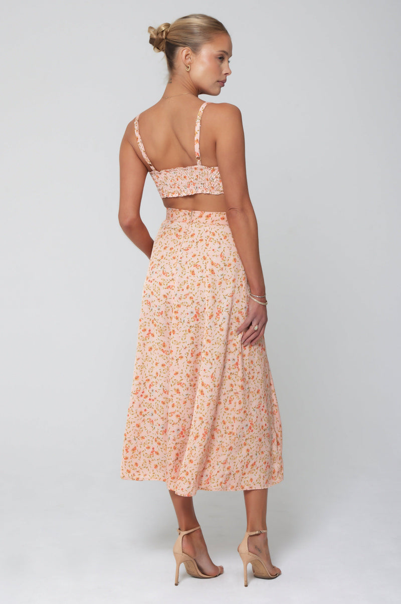 This is an image of Skatie Skirt in Sunstone - RESA featuring a model wearing the dress
