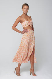 This is an image of Skatie Skirt in Sunstone - RESA featuring a model wearing the dress
