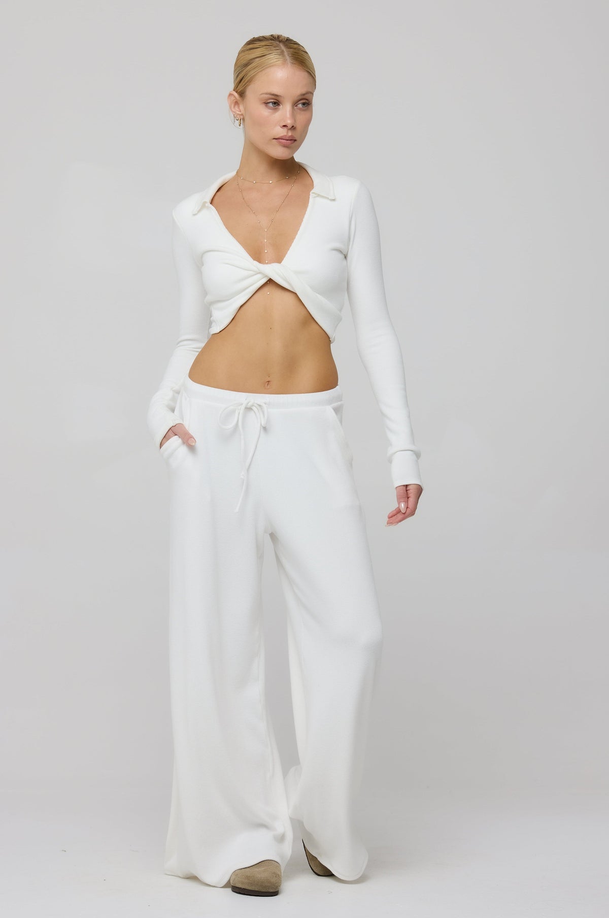 This is an image of Skylar Rib in White - RESA featuring a model wearing the dress