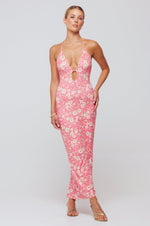 This is an image of Sophia Midi in Guava - RESA featuring a model wearing the dress