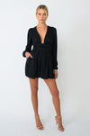 This is an image of Stevie Romper in Black - RESA featuring a model wearing the dress