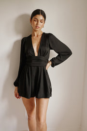 This is an image of Stevie Romper in Black - RESA featuring a model wearing the dress