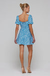 This is an image of Winnie Mini in Iris - RESA featuring a model wearing the dress