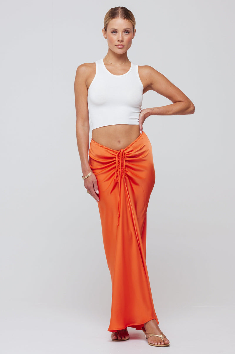 This is an image of Ziggy Skirt in Papaya - RESA featuring a model wearing the dress